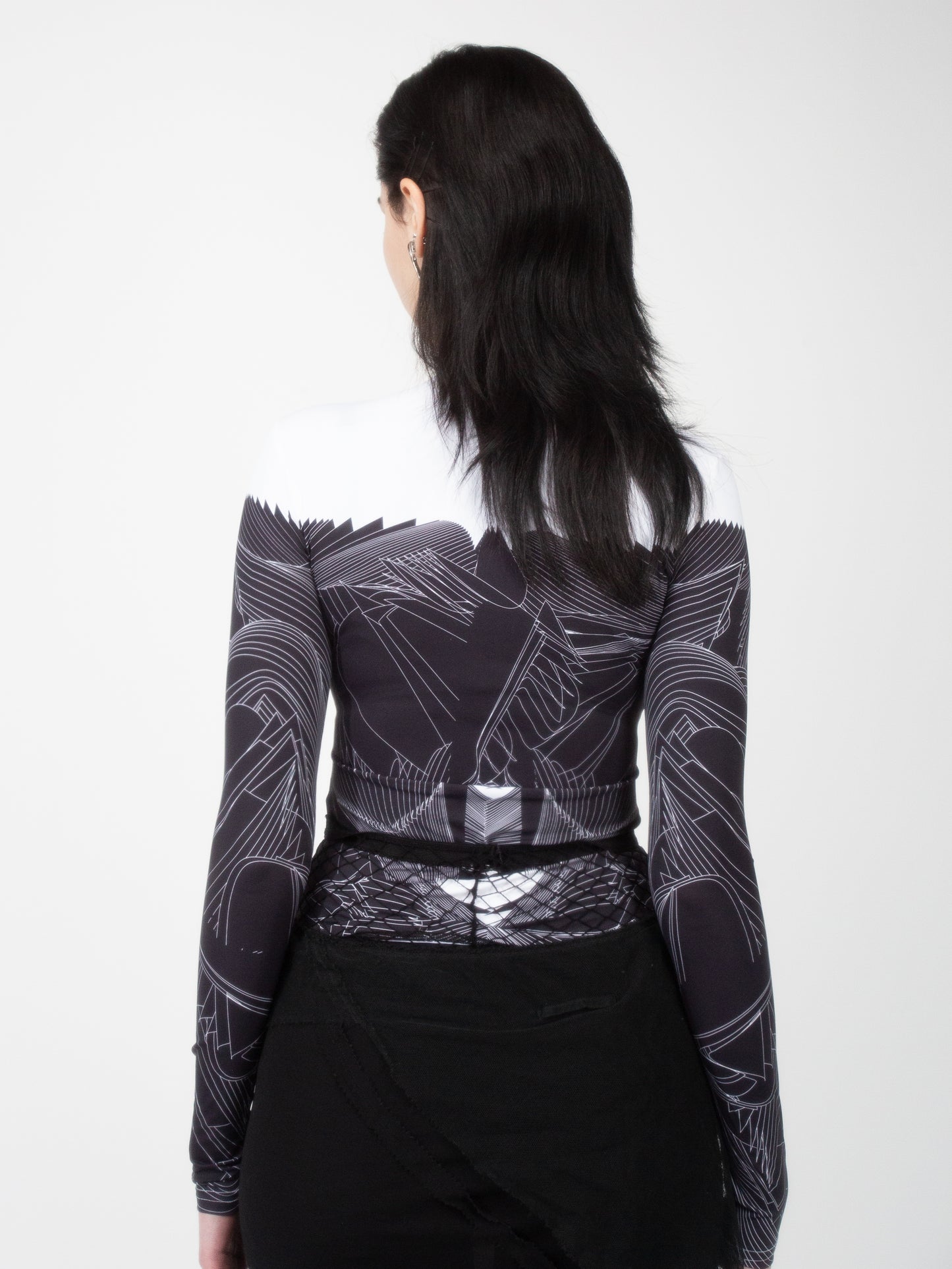 Back view of female model wearing VinöniV / VinoniV Obsidian Feather Daydream bodysuit jersey top with soft feather-inspired black and white design