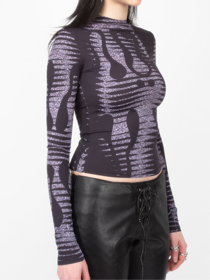 Side front view of female model model wearing VinöniV / VinoniV Noise fitted printed bodysuit jersey top in semi-purple color