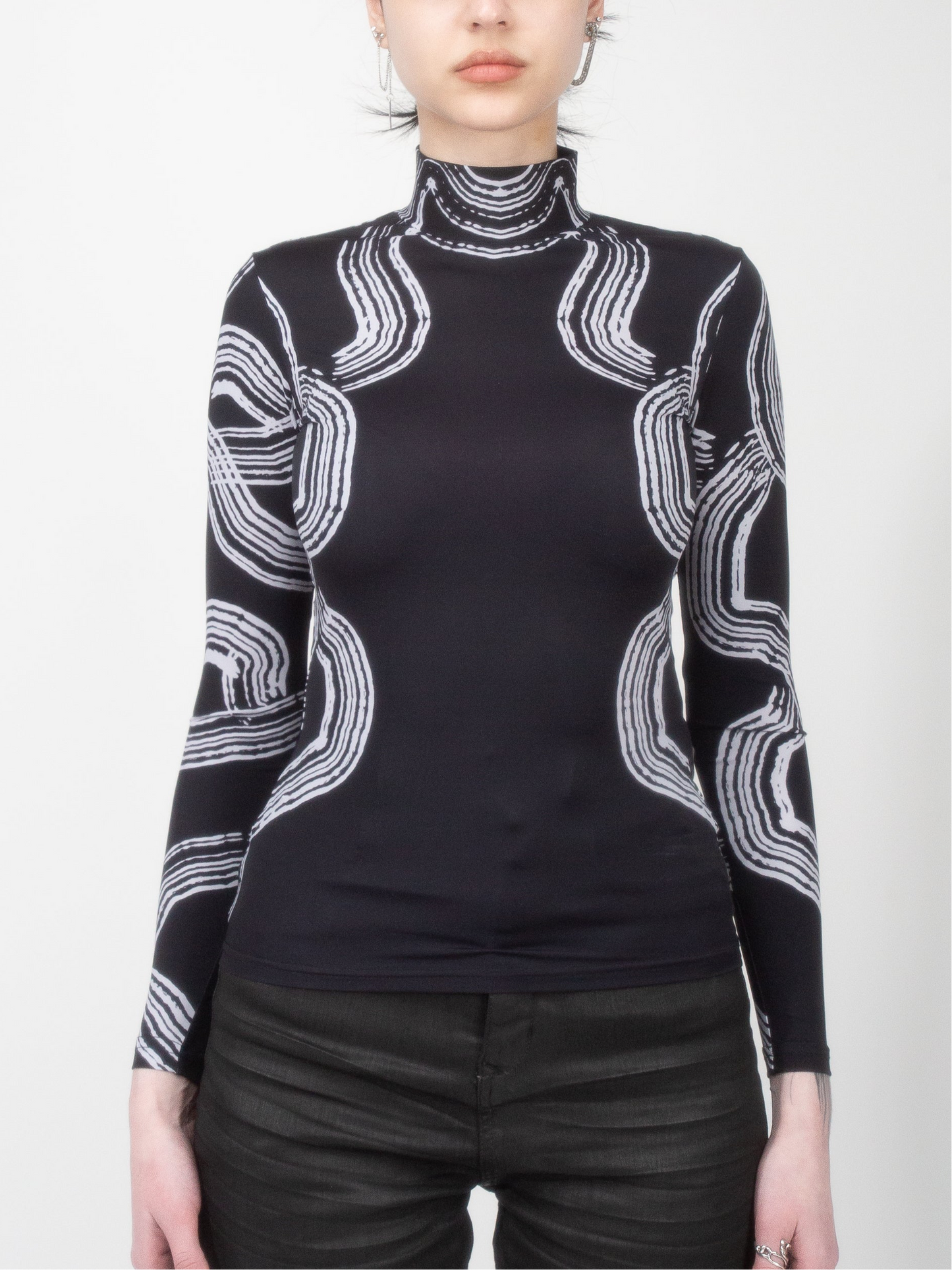 Front view of female model wearing Onyx Tide bodysuit jersey top black and white ocean print on jersey fabric by VinöniV / VinoniV featuring fluid, water-inspired design.