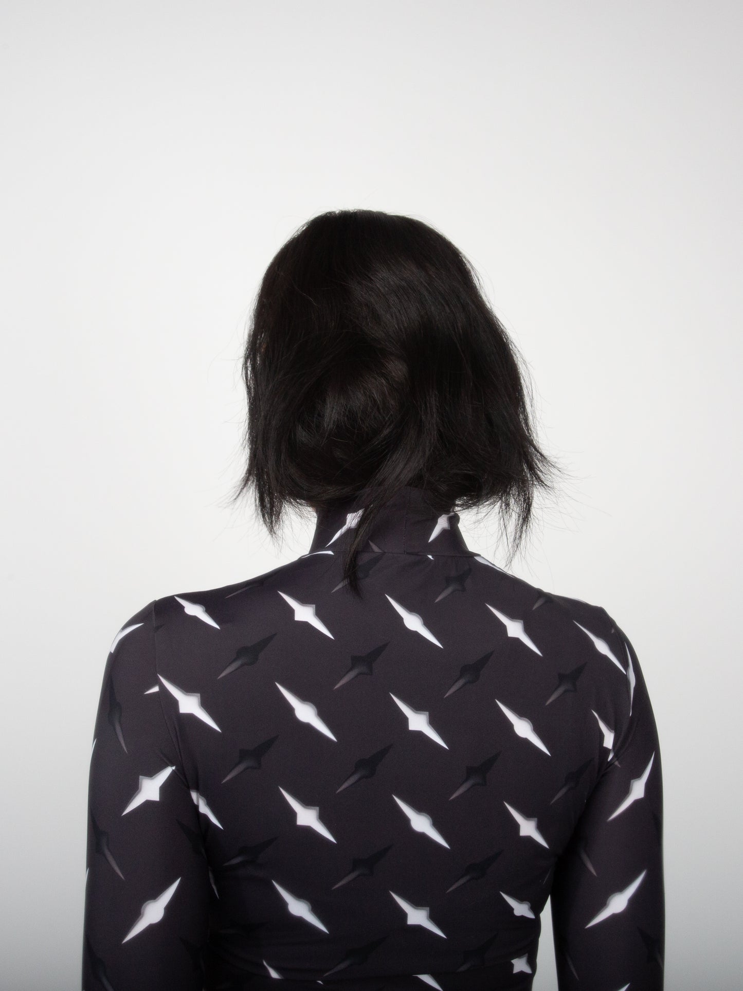 Female model back view close-up of Manhattan graphic print on fitted jersey top bodysuit by VinöniV / VinoniV