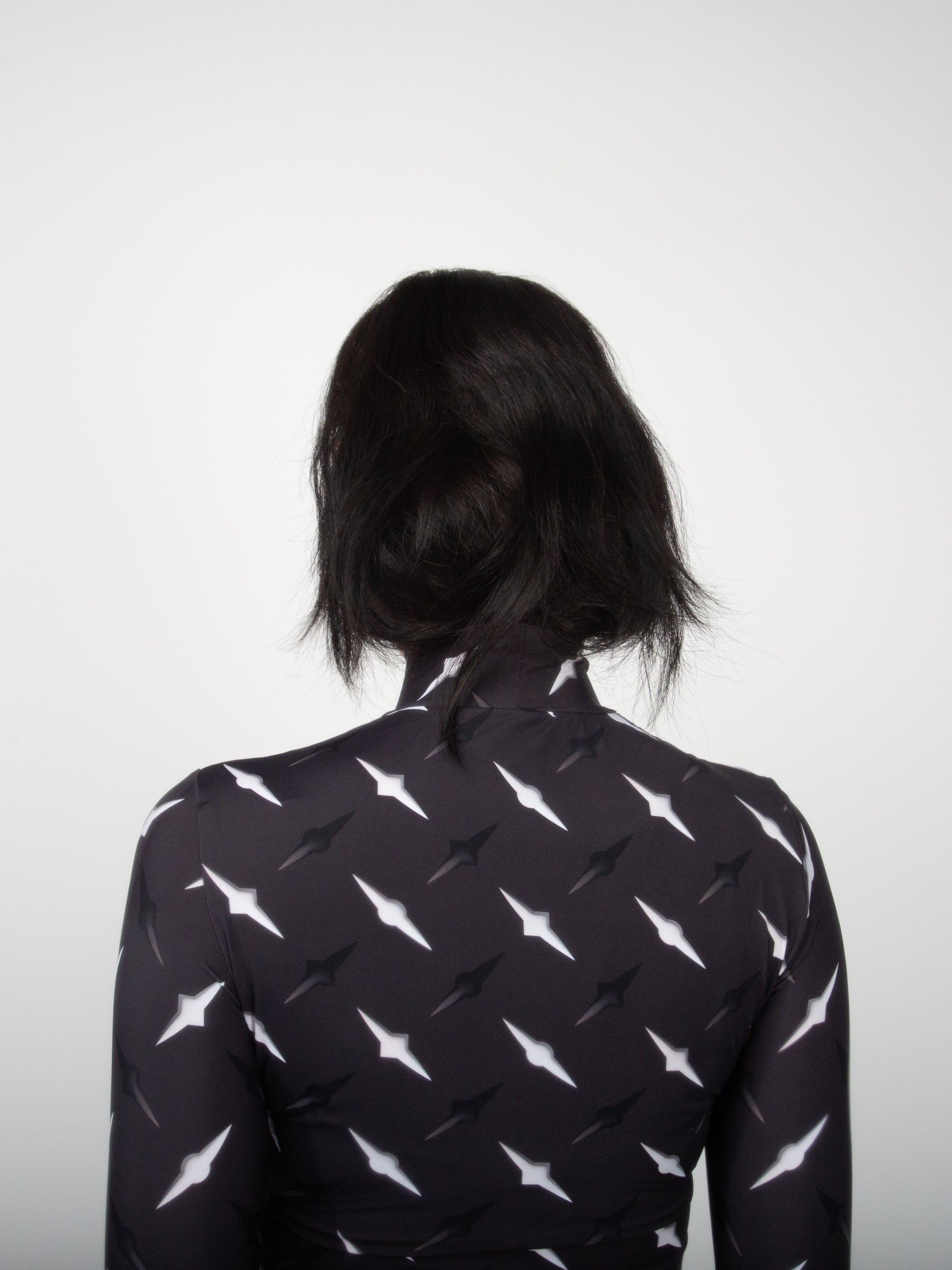Female model back view close-up of Manhattan graphic print on fitted jersey top bodysuit by VinöniV / VinoniV