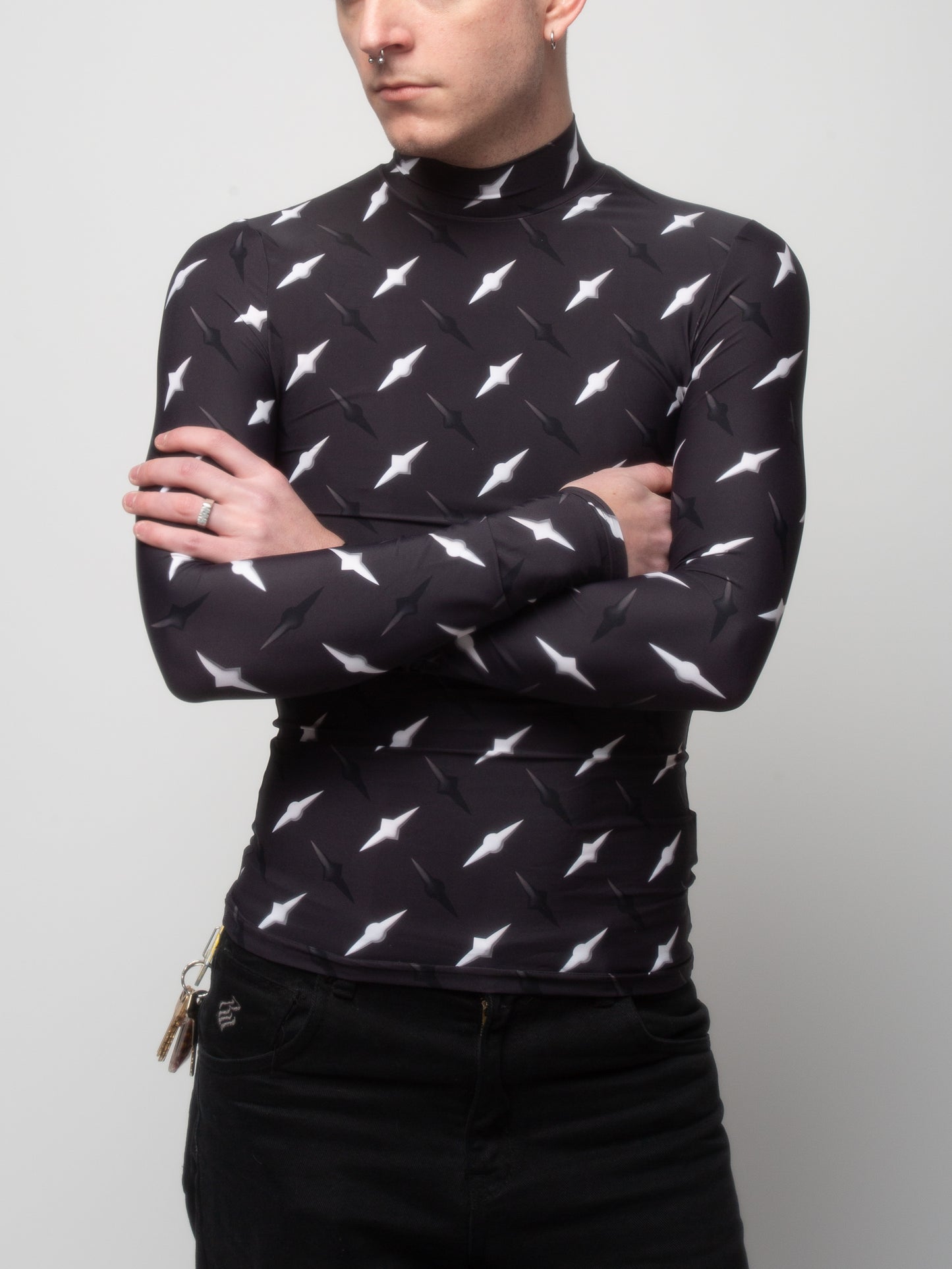 Male model side front view of wearing VinöniV / VinoniV Manhattan fitted bodysuit jersey top featuring New York City abstract cityscape-inspired pattern.
