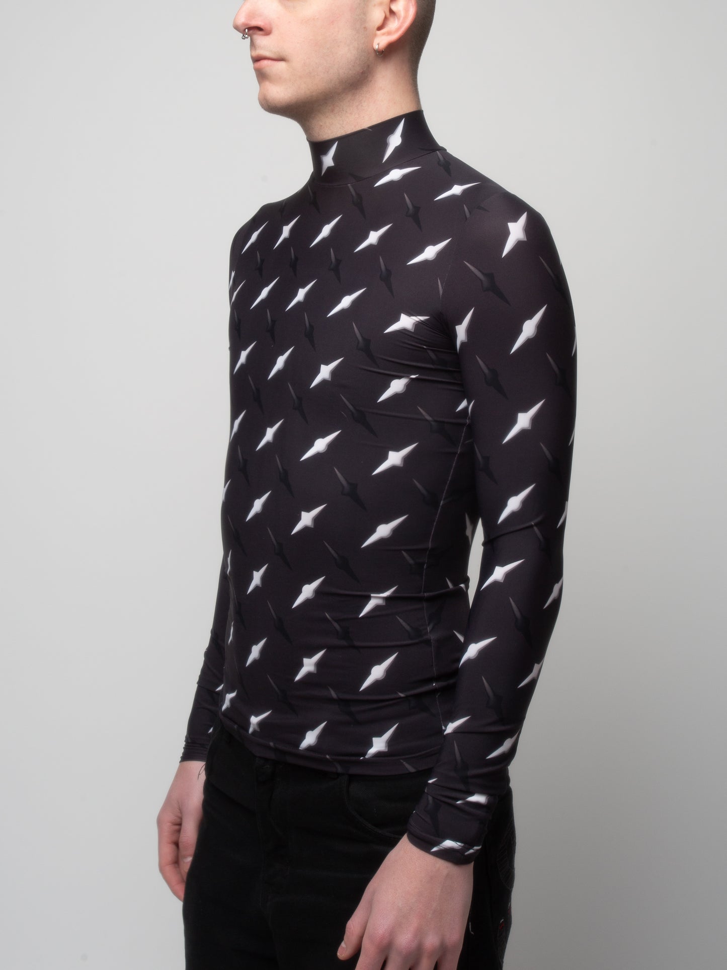 Male model side front view of wearing VinöniV / VinoniV Manhattan fitted bodysuit jersey top featuring New York City abstract cityscape-inspired pattern.