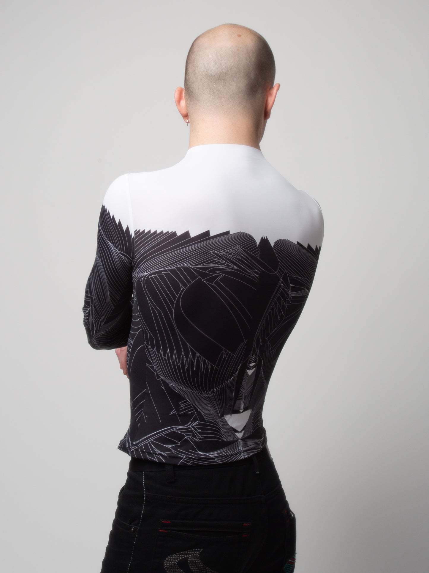 Back view of male model wearing VinöniV / VinoniV Obsidian Feather Daydream bodysuit jersey top with soft feather-inspired black and white design.