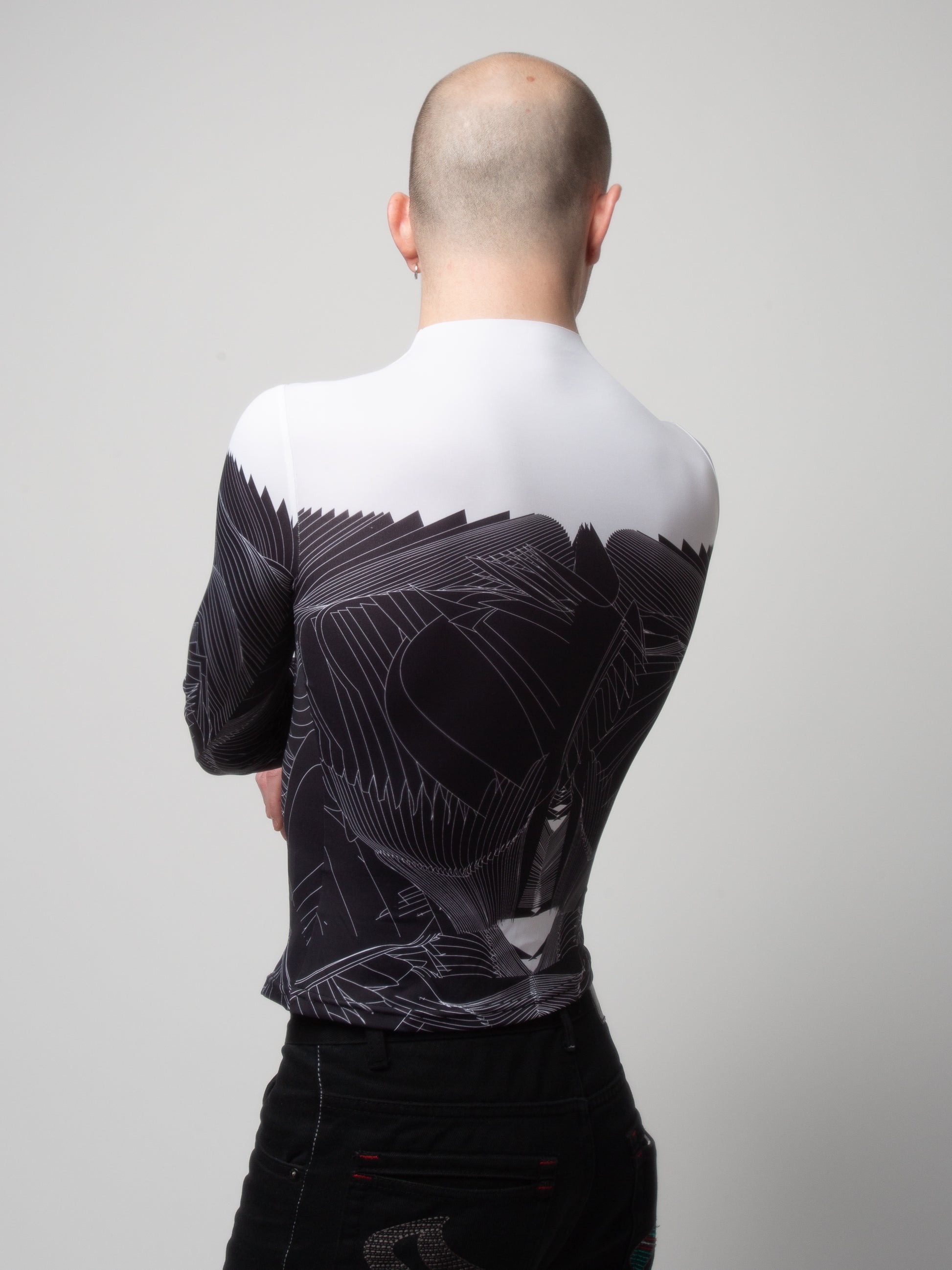 Back view of male model wearing VinöniV / VinoniV Obsidian Feather Daydream bodysuit jersey top with soft feather-inspired black and white design.
